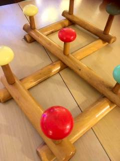 Portemanteau accordéon en bois, se déplie à volonté, 7 pommeaux de couleur vive en plastique, 2 accroches métal pour fixation murale, excellent état.